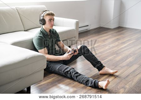 Young Attractive Man Playing Video Games In The Livingroom