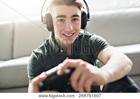 Young Attractive Man Playing Video Games In The Livingroom