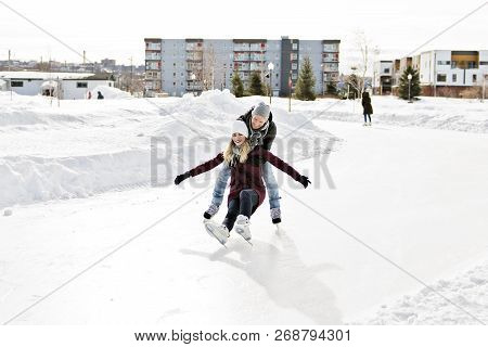 Couple In Sunny Winter Nature Ice Skating
