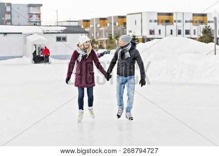 Couple In Sunny Winter Nature Ice Skating
