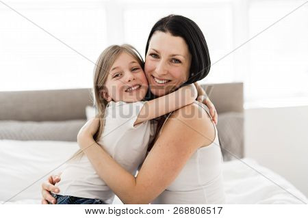 Mother And Daughter Enjoy In Bed At Home
