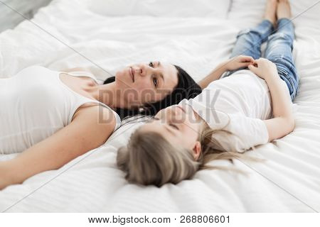 Mother And Daughter Enjoy In Bed At Home