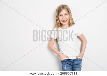 Happy Small Five Years Old Girl With Straight Hair Over White Background At Home