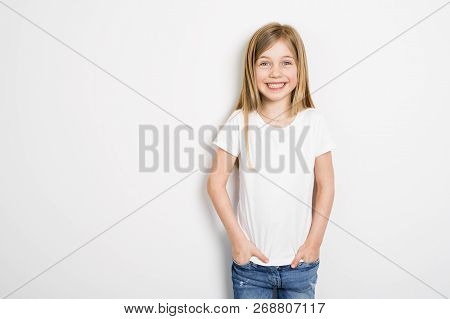 Happy Small Five Years Old Girl With Straight Hair Over White Background At Home