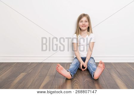 Happy Small Five Years Old Girl With Straight Hair Over White Background At Home
