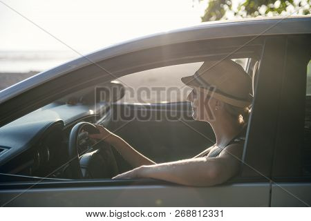 Woman Sitting In A Rental Car On Holiday Vacancy