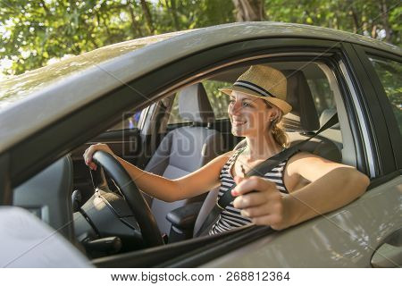 Woman Sitting In A Rental Car On Holiday Vacancy