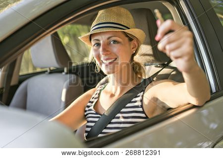 Woman Sitting In A Rental Car On Holiday Vacancy