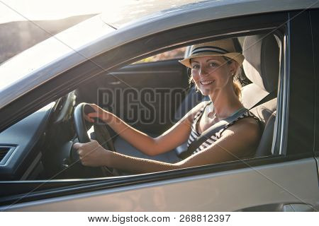 Woman Sitting In A Rental Car On Holiday Vacancy
