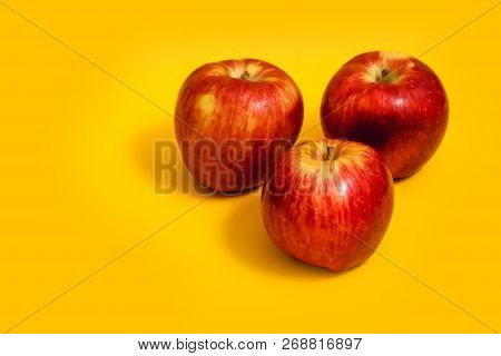 Big Red Apple With Yellow Background, Isolated.