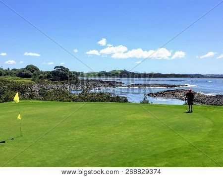 Waitangi, North Island, New Zealand - February 19th, 2016: A Man Lining Up A Putt While Golfing In W