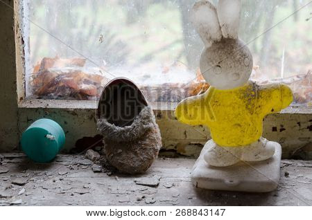 Children's Toy And Shoes On Windowsill In Abandoned Kindergarten In Destroyed Village Of Kopachi (ch
