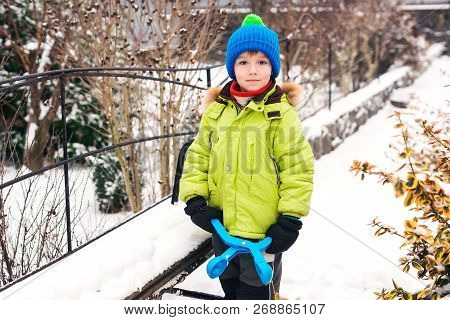Little Boy Makes Snowballs With Snowball Maker. Happy Child Playing With Snow. Cold Winter Weather. 