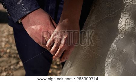 Bride And Groom Holding Hands Close Up