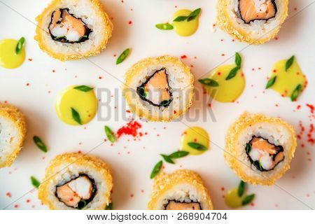 Sushi Rolls Scattered On White Background Top View