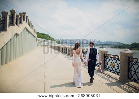 Stylish Bride And Groom Posing On The Background Of The River.