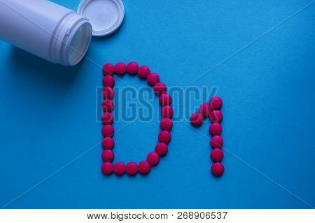 Pink Round Pills Lined With The Letter D1