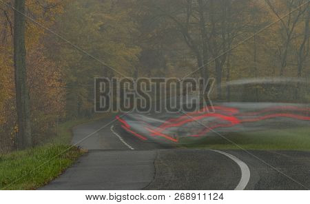 Car In Dark Fog Autumn Day Near Luhacovice Town