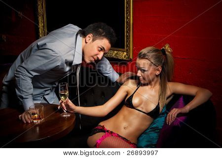 Drunk guy  flirting with stripteaser girl in night club