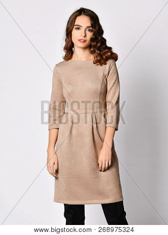 Young Beautiful Woman Posing In New Gray Suede Winter Fashion Dress Smiling On A White Background