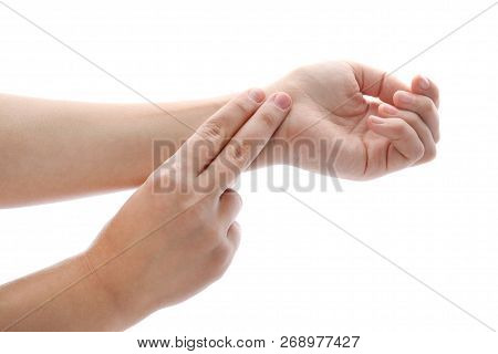 Woman Checking Pulse On Wrist Against White Background, Closeup