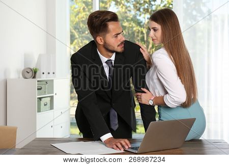Woman Molesting Her Male Colleague In Office. Sexual Harassment At Work