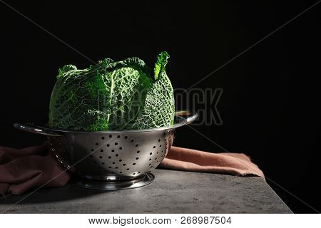 Colander With Savoy Cabbage On Table Against Black Background. Space For Text