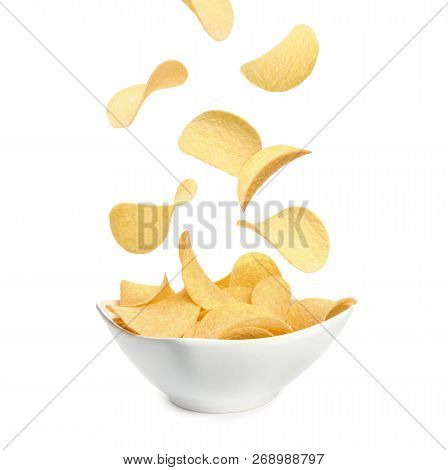 Tasty Potato Chips Falling Into Blow On White Background