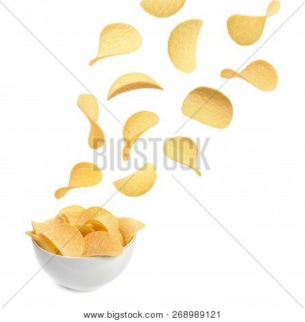 Tasty Potato Chips Falling Into Blow On White Background