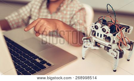 Little Boy In Shirt Programming Robot At Home. Young Boy In Shirt. Using Laptop. Modern Hobby Concep