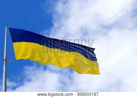 Large National Flag Of Ukraine Flies In The Sky. Big Yellow Blue Ukrainian State Flag In The Dnepr C