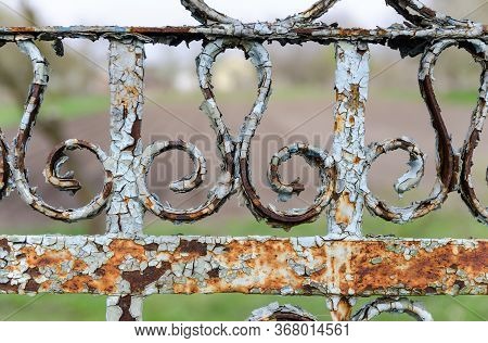 Old Metal Fence Close-up Perspective Background. Geometrical Pattern On A Shabby Vintage Messy Fence