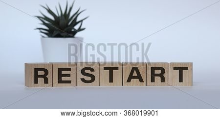 Wooden Blocks With The Text: Restart. New Business Relaunch Startup Concept.