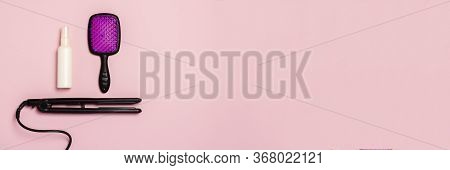 Hair Straightener, Comb And Hair Care Product On A Pink Background. Concept Of Hair Care, Hairstyle,