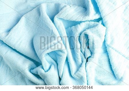 Large Folds Of A Terry Towel. Blue Color. Background.