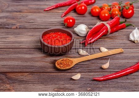 Ajvar Or Pindjur Red Vegetable Spread Or Pepper Paprika And Tomato Mousse In A Clay Bowl And Ingredi