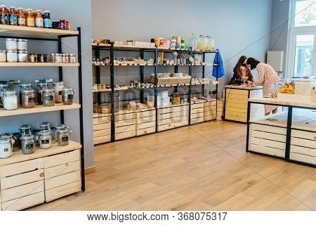 Zero Waste Shop Interior Details. Wooden Shelves With Different Food Goods And Personal Hygiene Or C