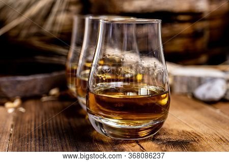 Speyside Scotch Whisky Tasting On Old Dark Wooden Vintage Table With Barley Grains Close Up
