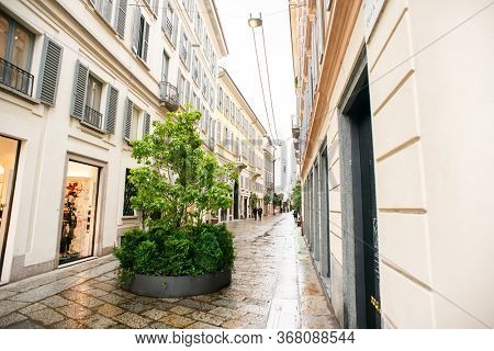 Milan. Italy - May 20, 2019: Della Spiga Street in Milan. Rainy Weather. Cloudy Sky.