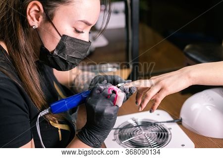 Close-up Of Hardware Milling Cutter For Removing Gel Polish. Apparatus Manicure In Beauty Salon. Man