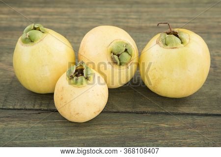 Rose Apple - Syzygium Jambos. Wood Background