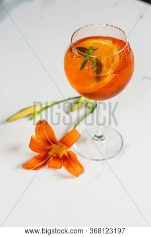 Aperol Spritz Cocktail In Glass On Table. Italian Alcoholic Cocktail Isolated On Wooden Background. 
