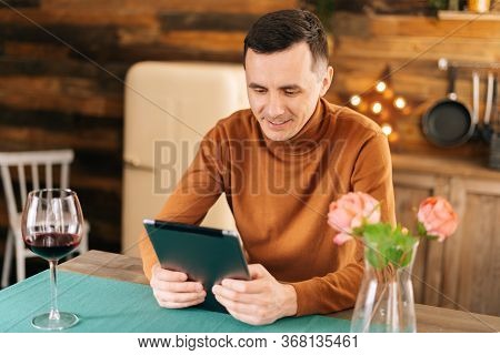 Romantic Young Happy Man Talking On Tablet With His Girlfriend During Isolation Due To The Coronavir