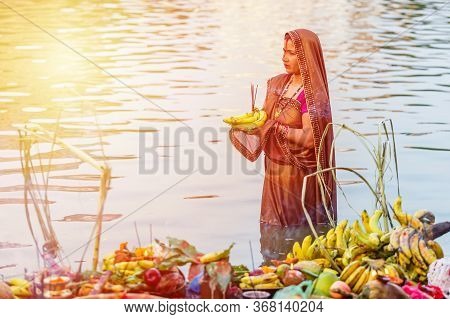 Kathmandu,nepal - November 1,2019: Hindu Devotee Offering Prayers To Sun God Standing In Water Accor