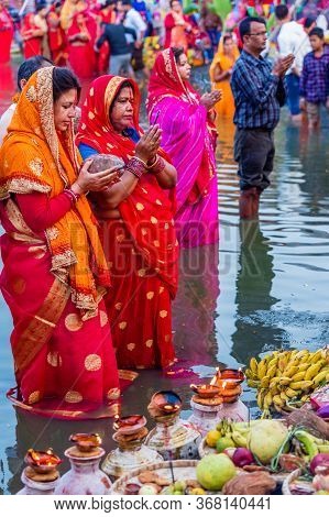 Kathmandu,nepal - November 1,2019: Hindu Devotees Offering Prayers To Sun God Standing In Water Acco