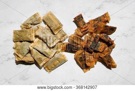 Two Kinds Of Swedish Snus Chewing Tobacco On A White Granite Background.