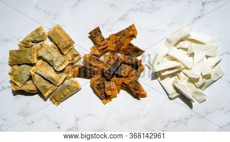 Three Different Types Of Swedish Snus Chewing Tobacco On A White Granite Background.