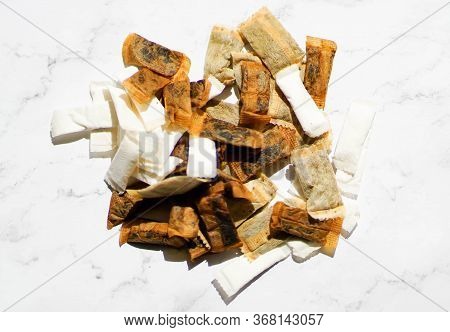 Swedish Snus Chewing Tobacco On A White Granite Background.