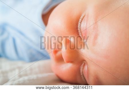 Newborn Sleeping Close Up. Baby Is Sleeping Soundly On The Bed And Copy Space. Infant Care, Colic, S