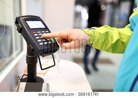Close-up Of Person Pressing Buttons On Card Machine. Mans Finger Entering Pin Code In Organization. 